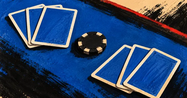Two fans of face-down cards with matching backs and one chip on blue felt