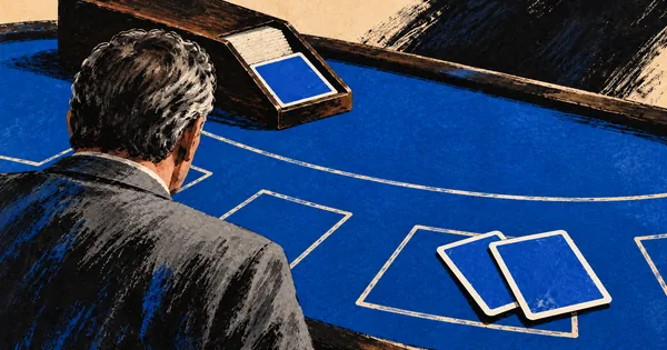 A man watching a blackjack table with a card shoe and two face-down cards